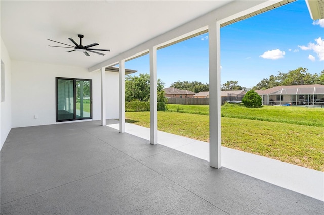 unfurnished sunroom with ceiling fan