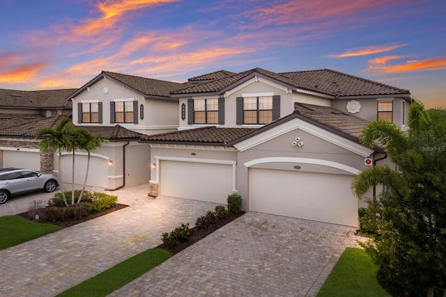 mediterranean / spanish house with a garage