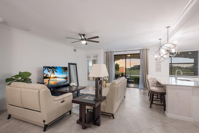 living room featuring sink, light tile floors, and ceiling fan with notable chandelier