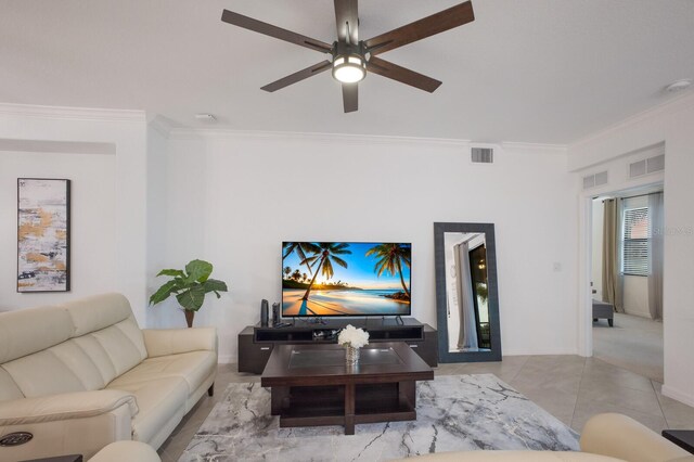 living room with ornamental molding, ceiling fan, and light tile floors