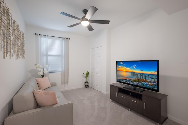 living room featuring light colored carpet and ceiling fan