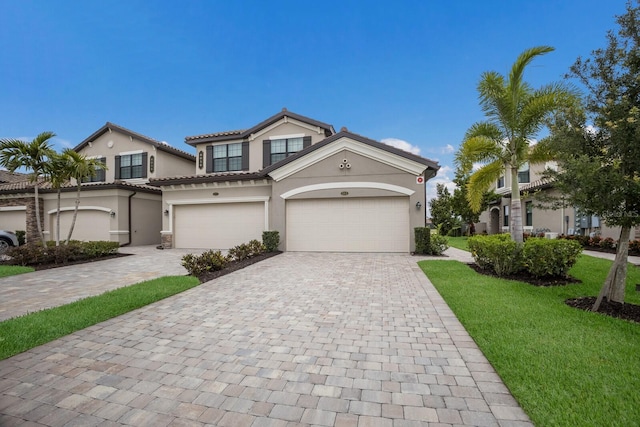 view of front of house with a garage and a front yard