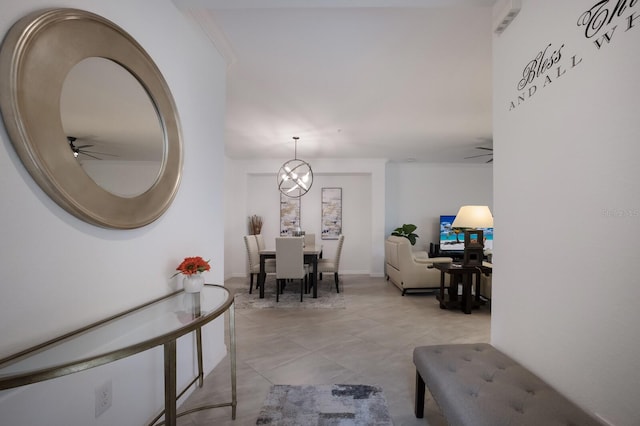 foyer entrance with light tile flooring and ceiling fan with notable chandelier