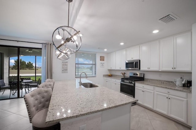 kitchen featuring an island with sink, white cabinetry, sink, and stainless steel appliances