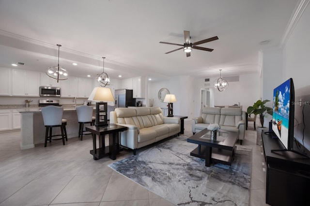 tiled living room with ornamental molding and ceiling fan with notable chandelier