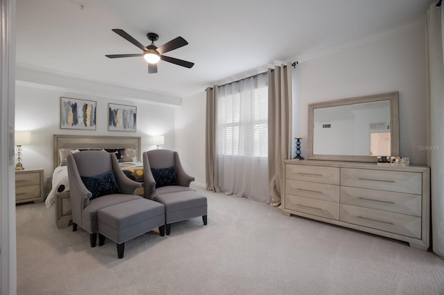 carpeted bedroom featuring ornamental molding and ceiling fan