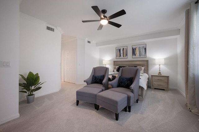 carpeted bedroom with ceiling fan and ornamental molding