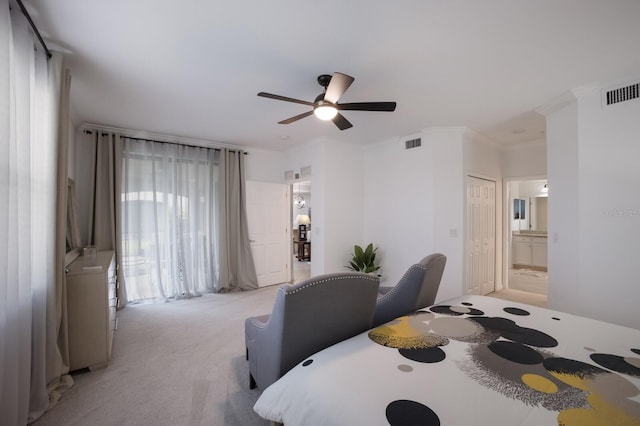 carpeted bedroom featuring ceiling fan, ornamental molding, a closet, and connected bathroom