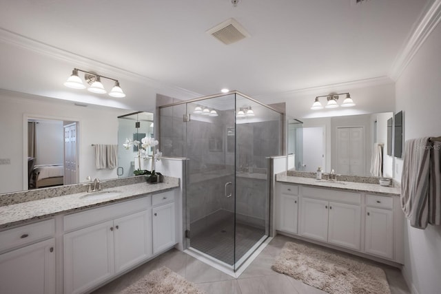 bathroom with crown molding, a shower with door, tile flooring, and vanity with extensive cabinet space