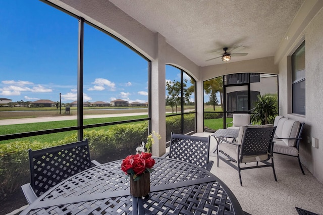 sunroom featuring ceiling fan