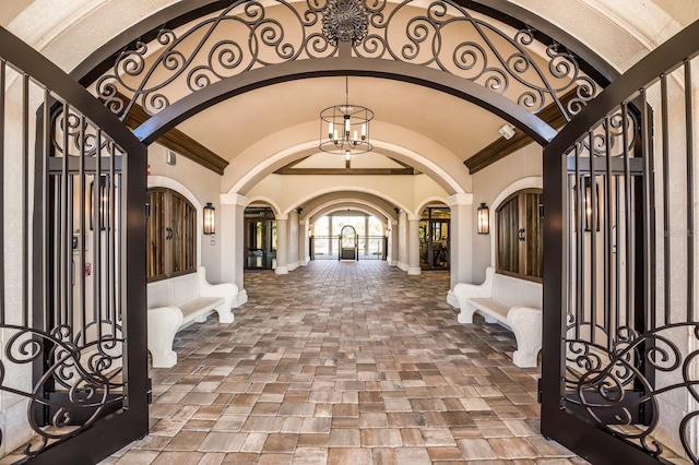 foyer entrance featuring crown molding and vaulted ceiling