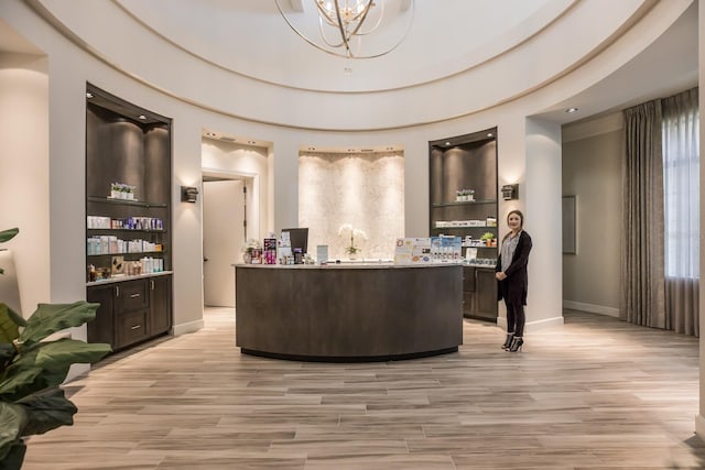 office area with a notable chandelier and light hardwood / wood-style flooring