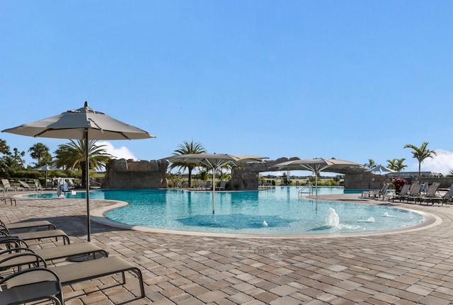 view of swimming pool with a patio area and pool water feature