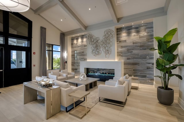 living room with high vaulted ceiling, beam ceiling, and light hardwood / wood-style flooring