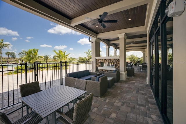 view of patio featuring an outdoor living space with a fireplace and ceiling fan