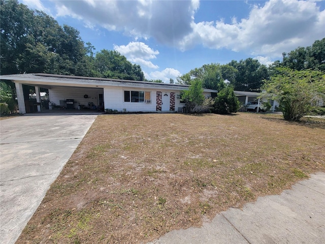 single story home featuring a front yard and a carport