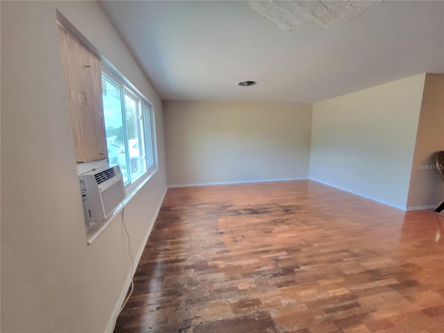 unfurnished room with hardwood / wood-style flooring