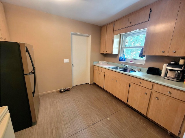 kitchen with sink and refrigerator