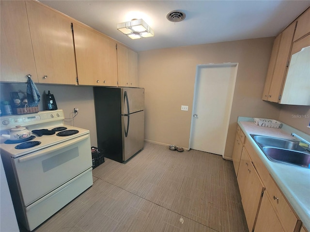 kitchen featuring light brown cabinets, white electric range, stainless steel fridge, sink, and light tile floors