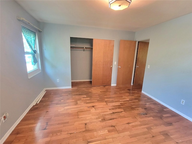 unfurnished bedroom featuring a closet and light hardwood / wood-style floors