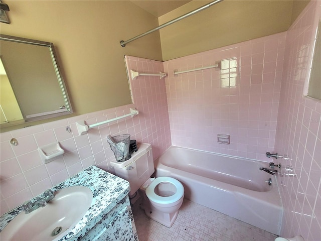 full bathroom featuring tile walls, toilet, tile floors, tasteful backsplash, and tiled shower / bath