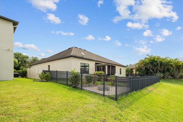 rear view of property featuring a yard