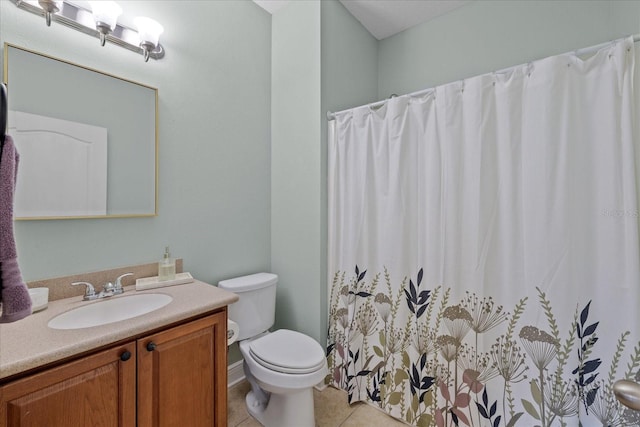 bathroom with toilet, tile patterned floors, walk in shower, and vanity