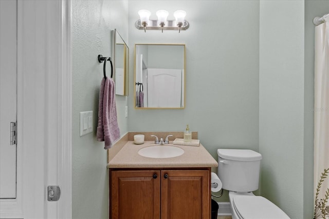 bathroom featuring vanity and toilet