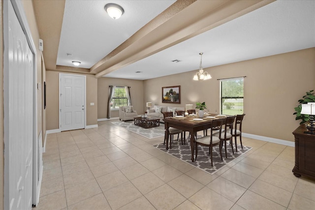 tiled dining area featuring a chandelier