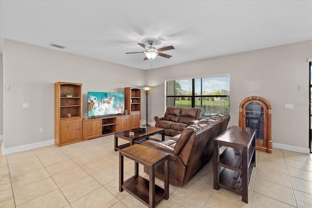 living room featuring ceiling fan and light tile patterned floors