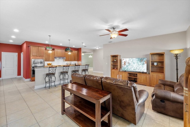 living room featuring ceiling fan and light tile patterned floors