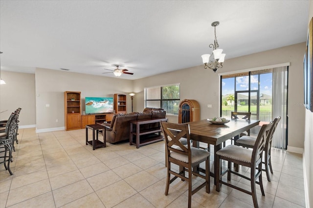 dining room featuring ceiling fan with notable chandelier and light tile patterned flooring