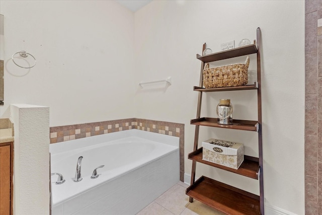 bathroom with tiled tub and tile patterned floors