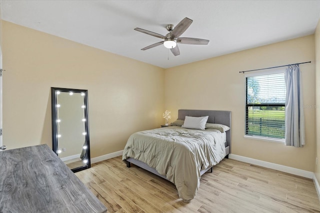 bedroom with ceiling fan and light wood-type flooring