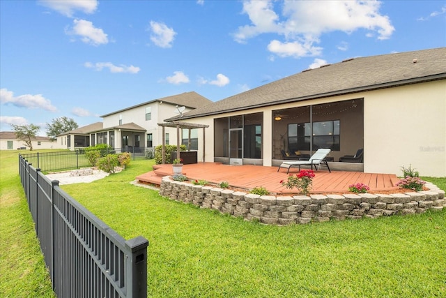 rear view of house with a pergola, a wooden deck, and a yard