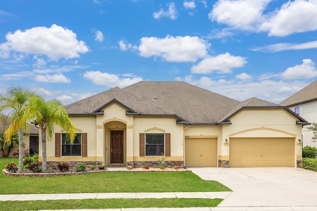 view of front facade featuring a front yard and a garage