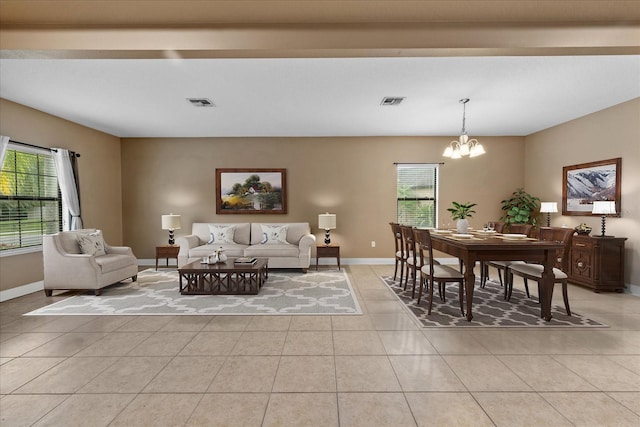 living room featuring light tile patterned floors and a chandelier