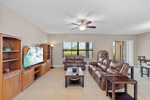 living room with ceiling fan and light tile patterned floors