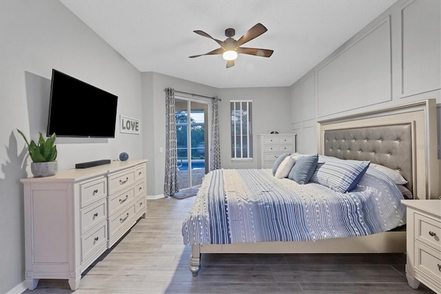 bedroom featuring ceiling fan, access to exterior, and light hardwood / wood-style floors