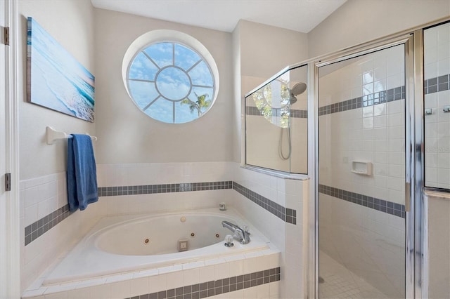 bathroom featuring separate shower and tub