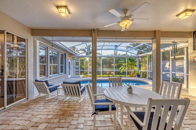 sunroom / solarium featuring ceiling fan