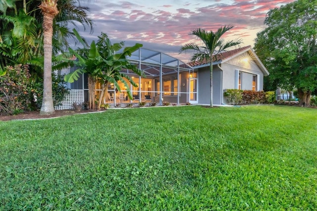 exterior space featuring a lanai and a yard