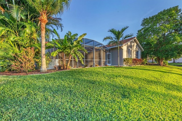 view of yard featuring glass enclosure