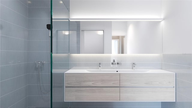 bathroom with a tile shower, decorative backsplash, vanity, and tile walls