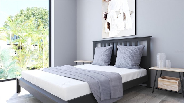 bedroom featuring wood-type flooring and multiple windows