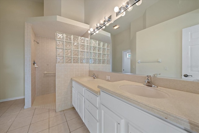 bathroom with tile patterned floors, vanity, and tiled shower