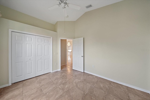 unfurnished bedroom with ceiling fan, light tile patterned flooring, lofted ceiling, and a closet