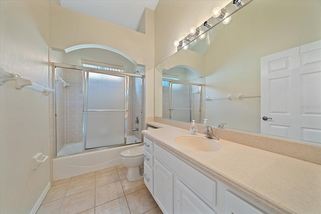 full bathroom with tile patterned floors, vanity, enclosed tub / shower combo, and toilet