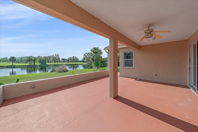 view of patio / terrace featuring a water view and ceiling fan