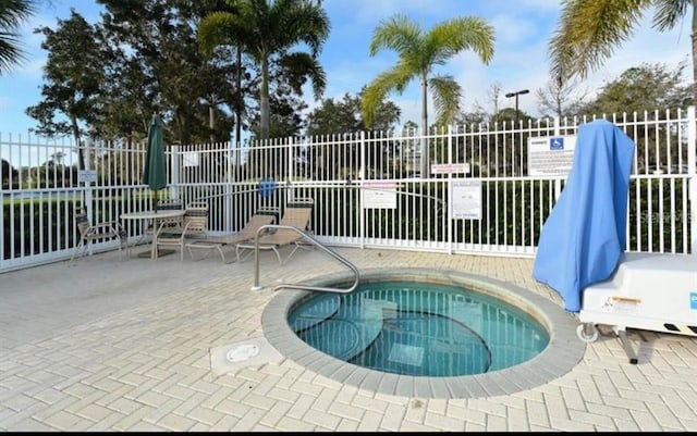 view of swimming pool with a patio area and a community hot tub